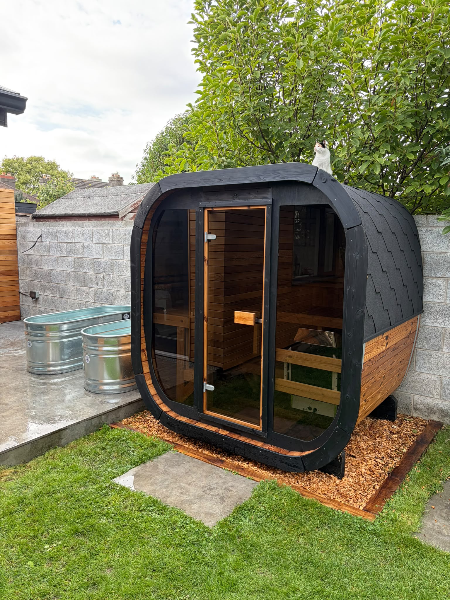 Completed four-seater Nordic pine cube sauna beside a garden room in Clontarf, Dublin